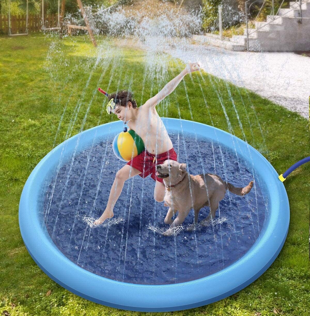 Child playing with a dog in an inflatable water play mat outdoors.