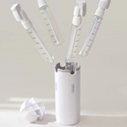 White handheld device with multiple spray nozzles on a light gray background