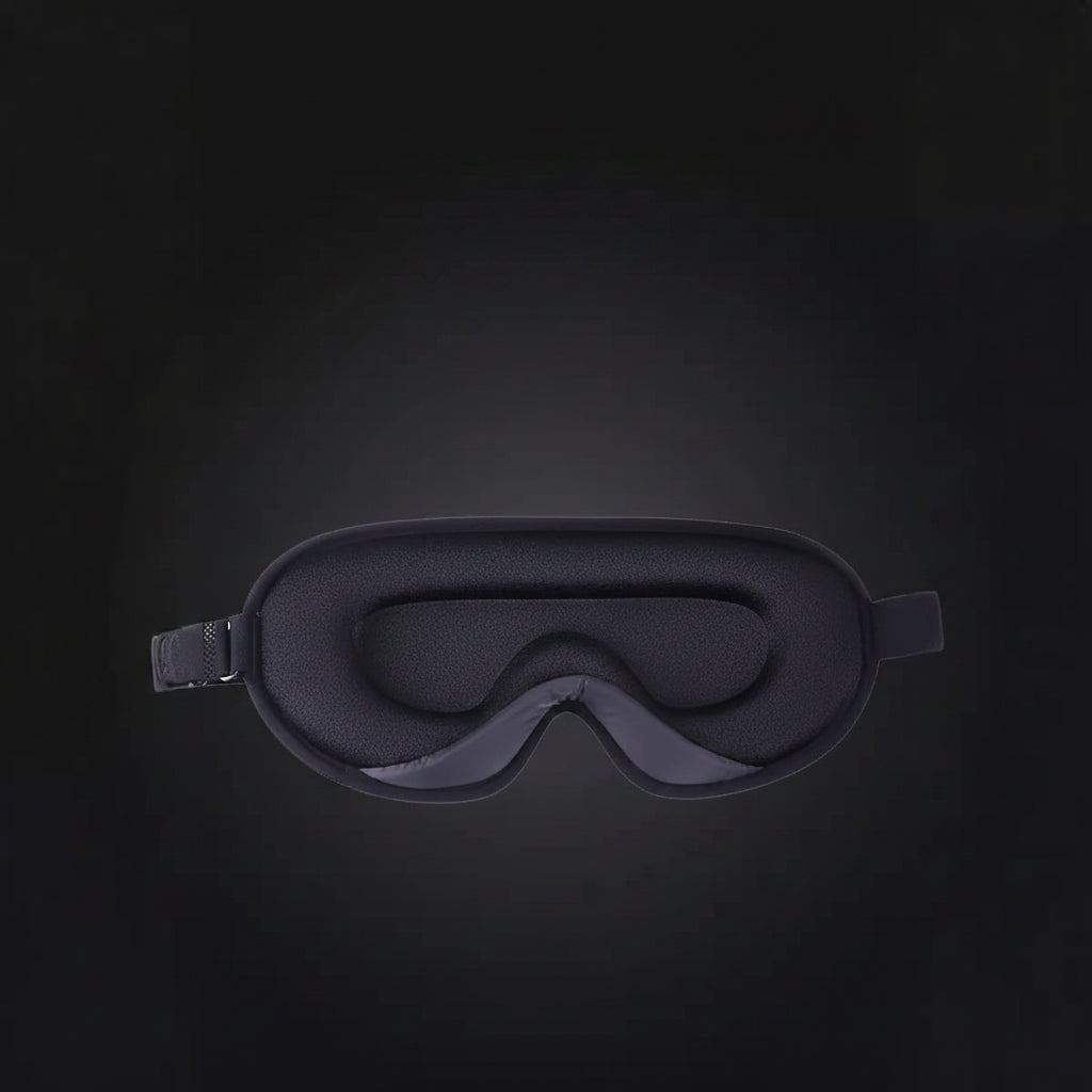 Black sleep mask on a dark background with text