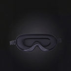 Black sleep mask on a dark background with text