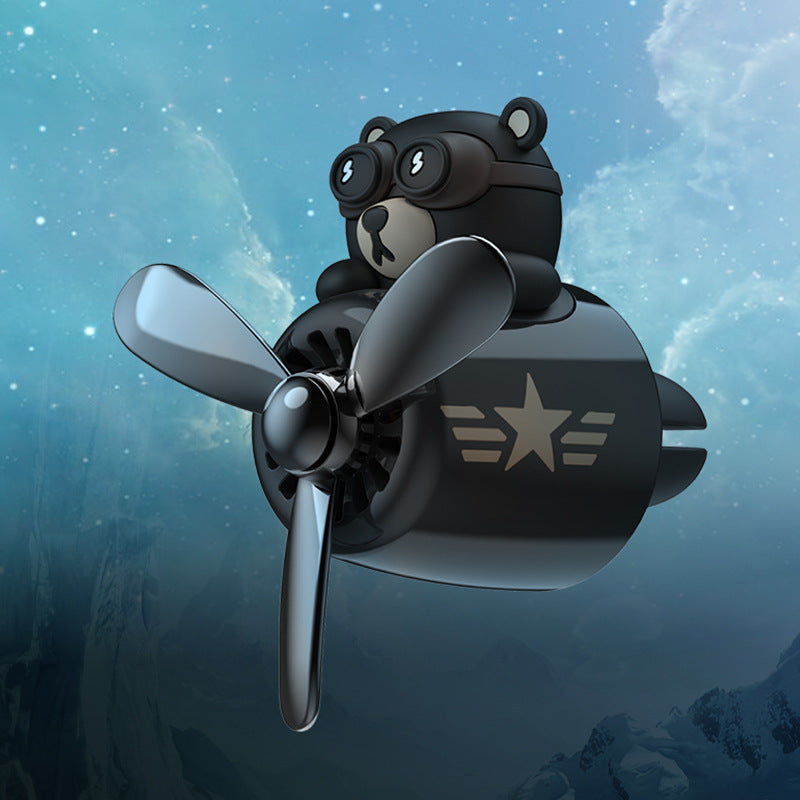 Teddy bear with goggles and a propeller cute car air freshener against a starry sky