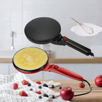 Roti maker with a cooking surface and an egg beater attachment on a kitchen counter.