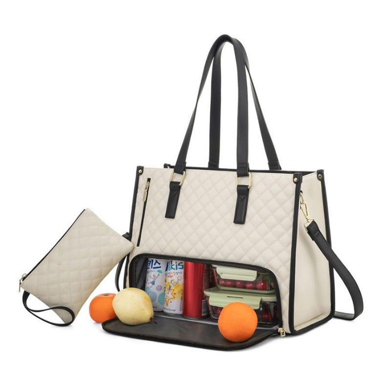 Beige handbag with black handles and trim, open to reveal items inside on a white background