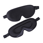 Two black sleep masks on a white background